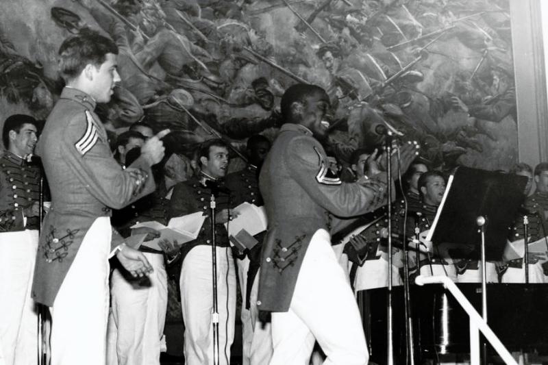 Cadets Mark A. Draper, Class of 1984 and David A. Twillie, Class of 1985 lead the audience in a song at a VMI Glee Club concert in Memorial Hall.