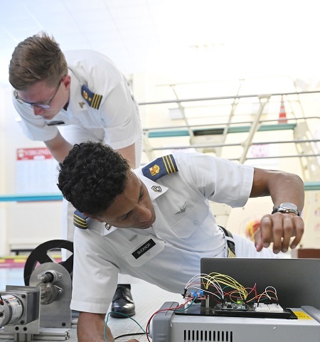 Cadets tinkering with computer parts.