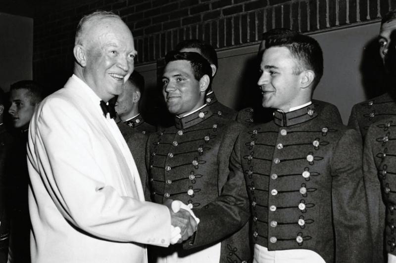 President Dwight D. Eisenhower shakes hands with Cadet Andrew J. Thacker, Class of 1961. The President met with Thacker and other members of the VMI Glee Club  after they entertained guests at the Federal Housing Administration Banquet in Washington, D.C. on June 18, 1959.