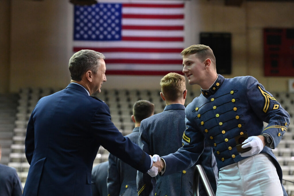 Grant Rose shakes Gen. Dan Caine's hand at Ring Figure.