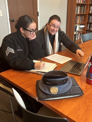 Delilah Martindale discusses her research with mentor Dr. Vera Heuer.