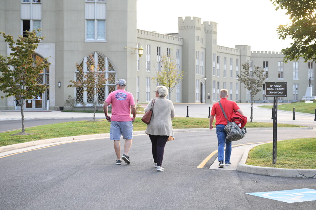 Parents with their child walking to barracks for an open house at VMI.