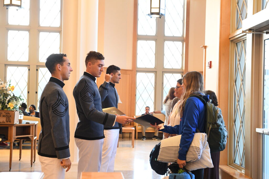 Cadets greet prospective students during an open house.