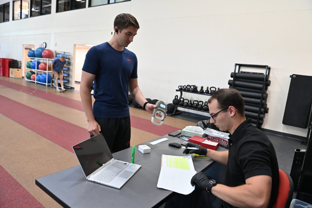 A college student works with his faculty mentor while conducting research.