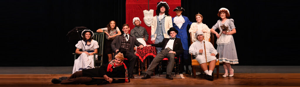 VMI theatre cadet drama group members on stage dressed in period costumes.