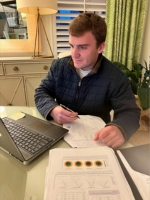 Harrison Williams works on his research at a laptop.