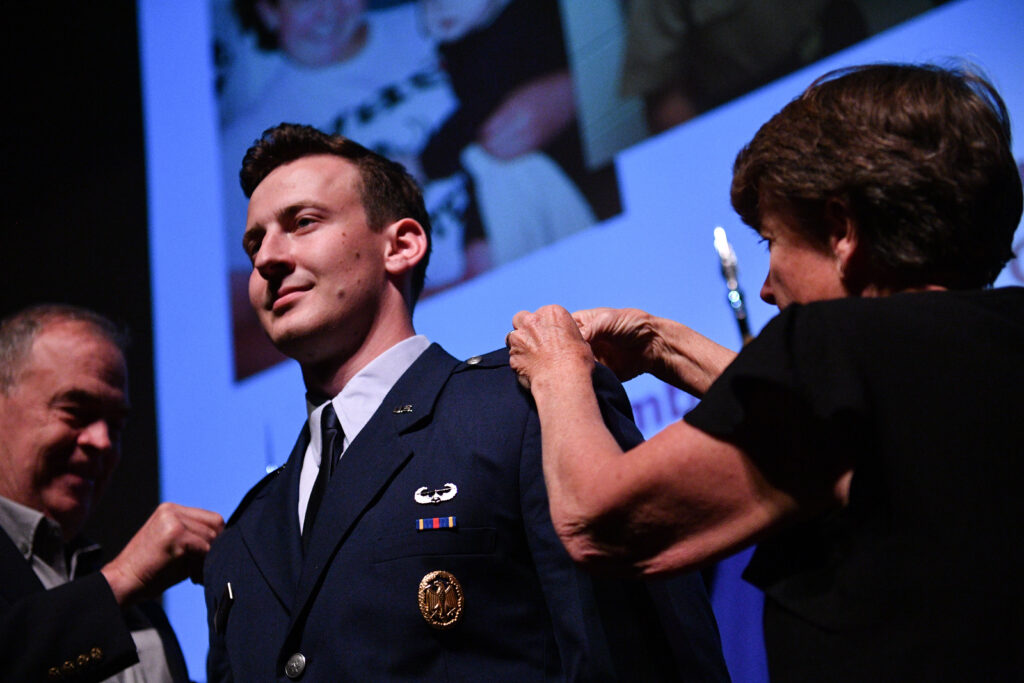 A newly commissioned Second Lieutenant receives his insignia from family during the Air Force ROTC pin-on ceremony at VMI.