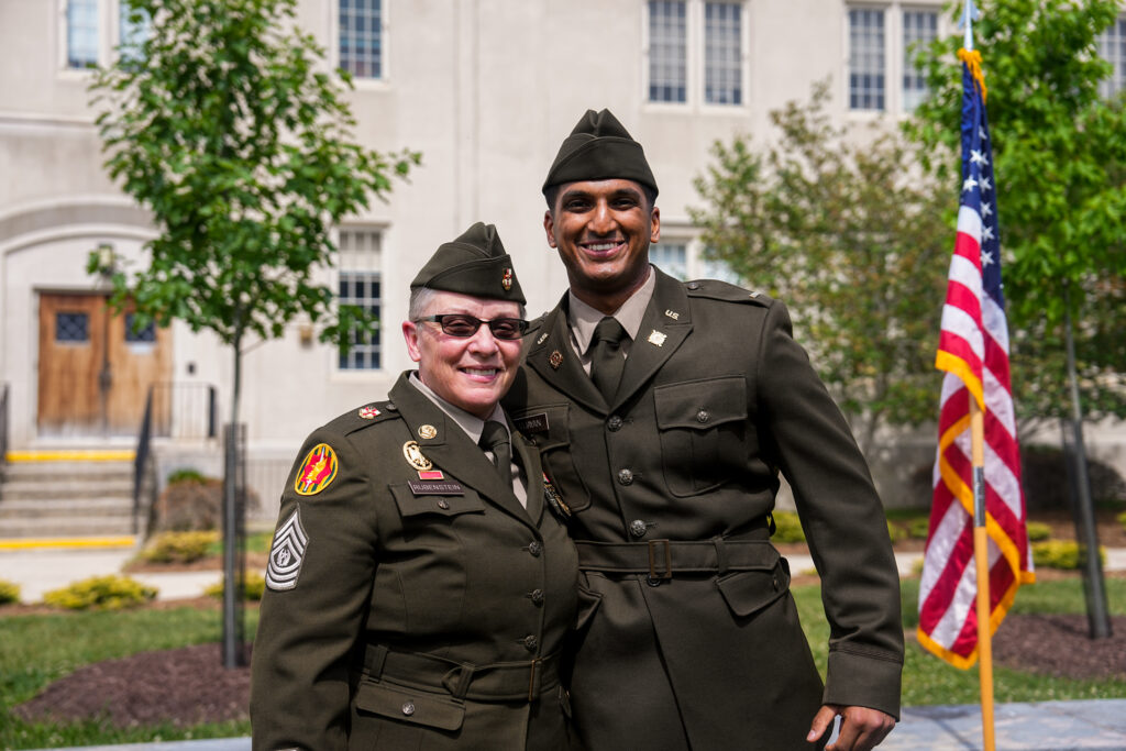 A newly commissioned officer poses with CSM Rubenstein, a member of the Commandant's staff at VMI.