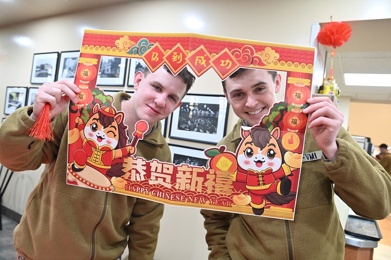 Two cadets pose for a photo with a Lunar New Year frame.