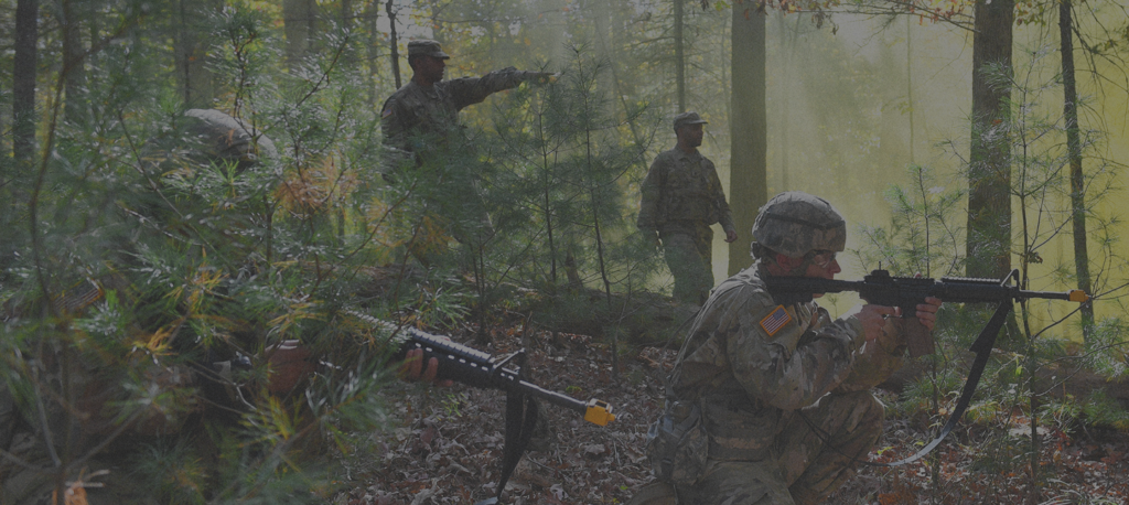 Cadets in a forest, practicing operations as part of Marines ROTC.