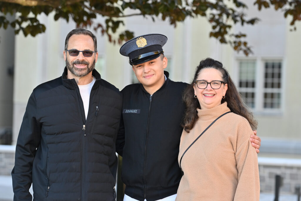 Cadets pose with their family members during family weekend.